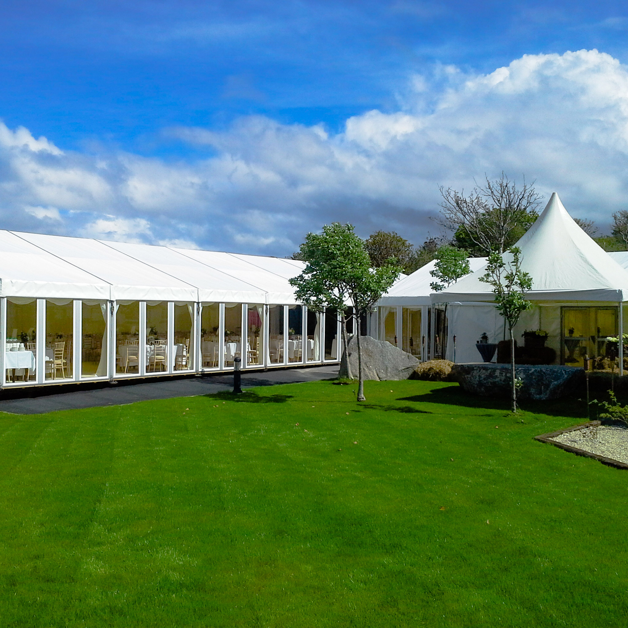 A wedding marquee adjacent to green grass photographed in daylight