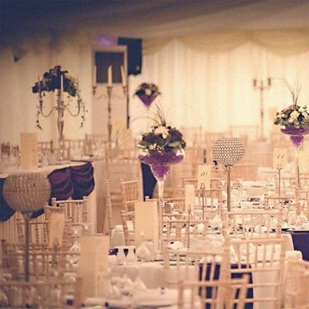 A photograph of tables set at a marquee wedding function